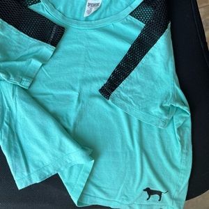 Pink crop shirt with mesh detail. Teal color